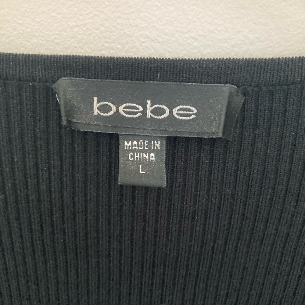 Black 3/4 sleeve top (very low cut) by Bebe.